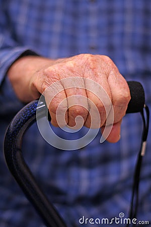 Elderly man's hand on cane Stock Photo