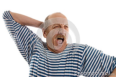 Elderly man in a stripped vest yawns Stock Photo