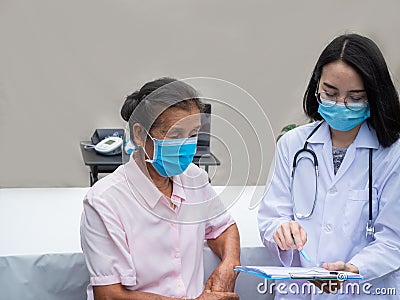 Elderly medicalcare. healthcare for senior women to improve global immunity. doctor explianing and consulting from a chart with Stock Photo
