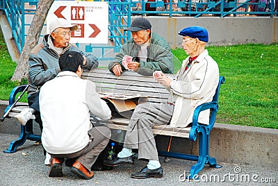 Elderly men enjoy a card game Editorial Stock Photo