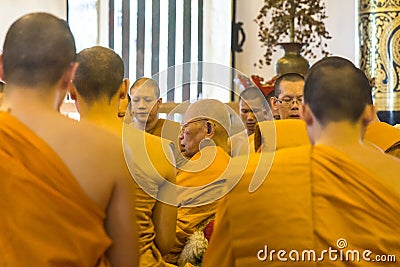 Elderly monk praying among others Editorial Stock Photo