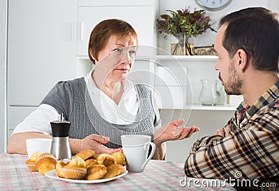 Elderly mother teaches her son Stock Photo