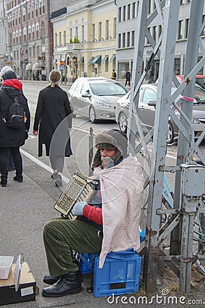 elderly musician playing the accordion on the street Editorial Stock Photo