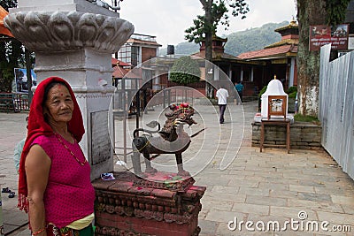 Elderly Nepali woman and temple, Pokhara, Nepal Editorial Stock Photo