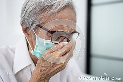 Elderly patient has ill,fever and coughing or sneezing,asian senior woman wearing a mask and isolation,quarantine to prevent the Stock Photo