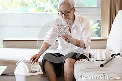 Elderly people is checking expiration date or deterioration of medication before use in the treatment,senior woman reading pill Stock Photo