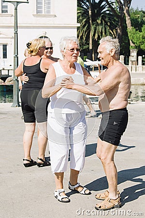 Elderly people dance and enjoy life outside on the waterfront of the island. Editorial Stock Photo
