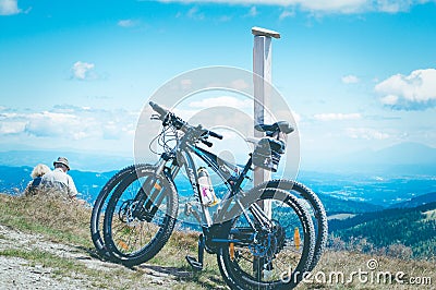 Elderly people, man and woman, enjoy the view of the mountains, relax in the mountains after a bike ride. Editorial Stock Photo