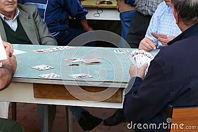 Elderly people playing cards Stock Photo