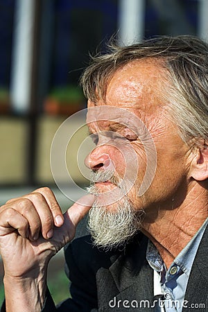 Elderly sad tramp. Stock Photo