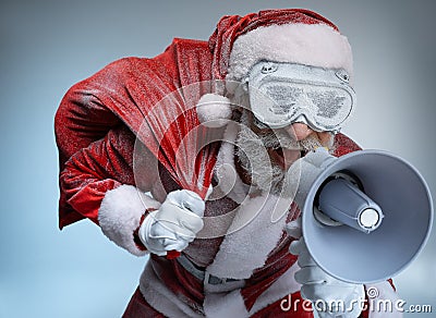 Elderly Santa Claus with sack speaking at megaphone Stock Photo