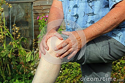 Knee pain. Arthritis. Senior in pain. Stock Photo