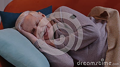 Elderly smiling man grandfather sleeping quietly lying on bed at home, healthy good peacefully sleep Stock Photo