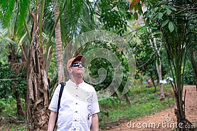 Elderly tourist in the jungle Stock Photo