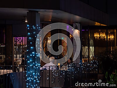 Elderly White Caucasian couple dining al-fresco at Joie vegetarian restaurant, Orchard Central, Orchard Road Singapore Editorial Stock Photo