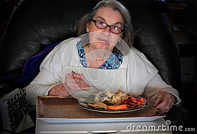 Elderly woman eating dinner Stock Photo