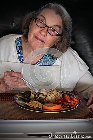 Elderly woman eating lunch Stock Photo