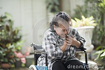 woman have heart disease sitting on wheelchair Stock Photo