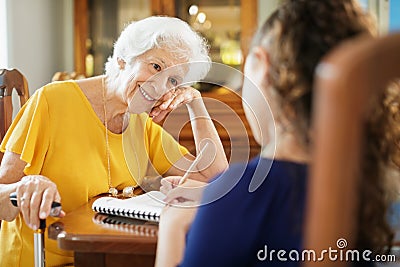 Elderly Woman Helping Little Girl Doing School Homework Stock Photo