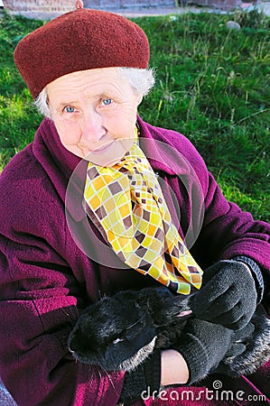 Elderly woman hold rabbit Stock Photo