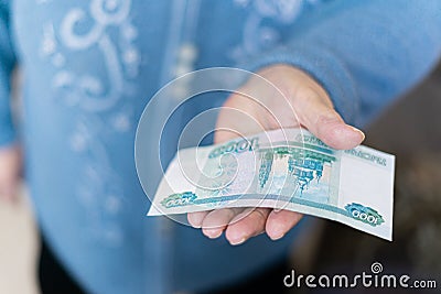 Elderly woman in money in her hands, grandmother holds money Stock Photo