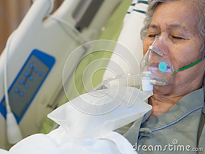 Elderly woman patients with lung disease, getting oxygen for treatment in the room at the hospital. Space for text Stock Photo