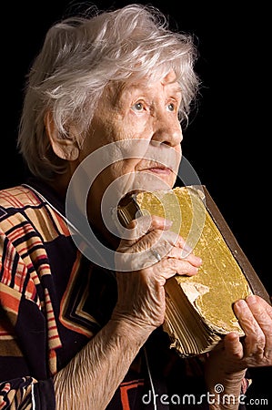 Elderly woman reads the book Stock Photo