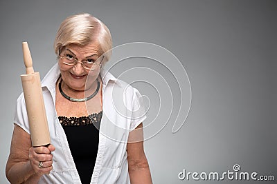 Elderly woman with rolling pin Stock Photo