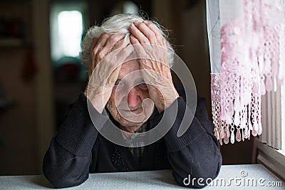 An elderly woman in a state of depression. Pensioner. Stock Photo