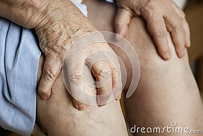 Elderly woman suffering knee pain Stock Photo