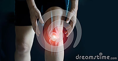 Elderly woman suffering from pain in knee. Tendon problems and Joint inflammation on dark background Stock Photo