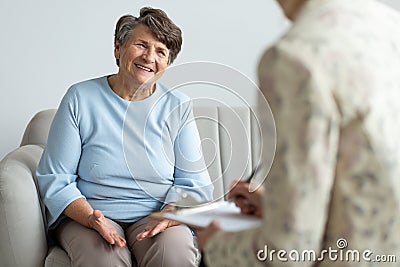 Elderly woman talking to a financial advisor about a loan Stock Photo