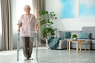 Elderly woman using walking frame indoors. for text Stock Photo