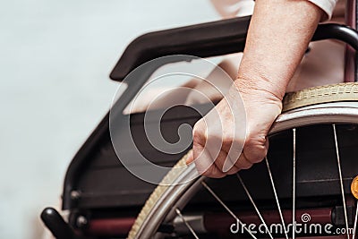 Elderly woman using wheelchair. Stock Photo