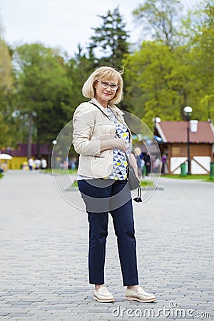 Elderly woman walking in spring park Stock Photo