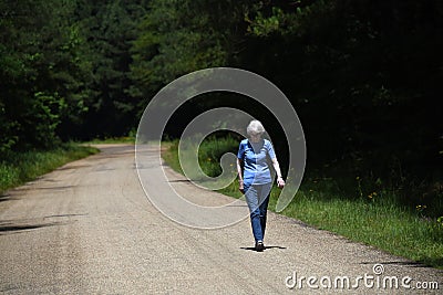 Elderly Woman Walks for Exercise Stock Photo