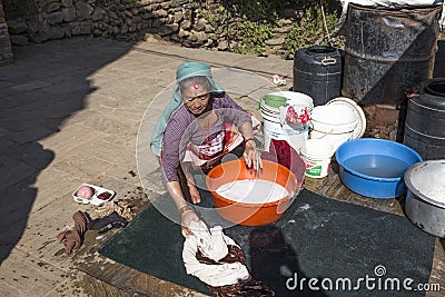 Elderly woman washes the dirty laundry in Kathmandu, Nepal Editorial Stock Photo