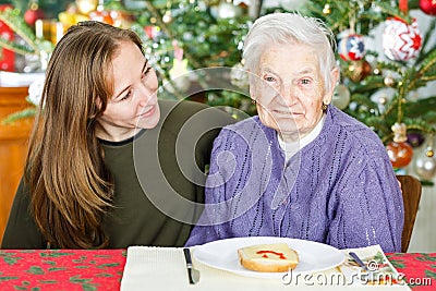 Elderly woman and young carer Stock Photo