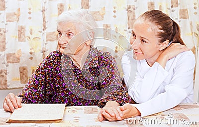 Elderly woman with the young smileing doctor Stock Photo