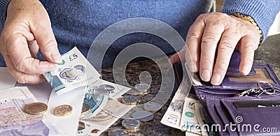 Woman with purse and UK money Editorial Stock Photo