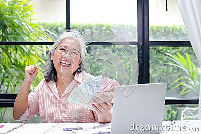 Elderly women do household income and expenses. Stock Photo