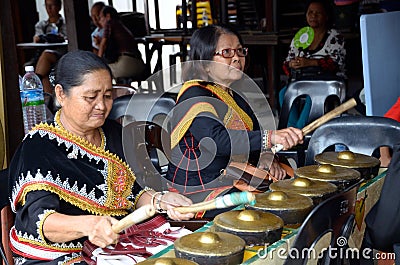 Elderly women playing gong Editorial Stock Photo