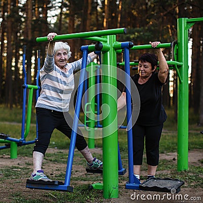 Elderly woman on a sports simulator in the Park. Stock Photo