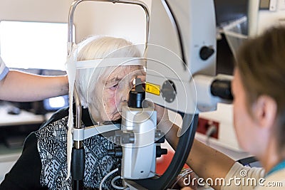 Senior woman during laser surgery at ophthalmology clinic. Stock Photo