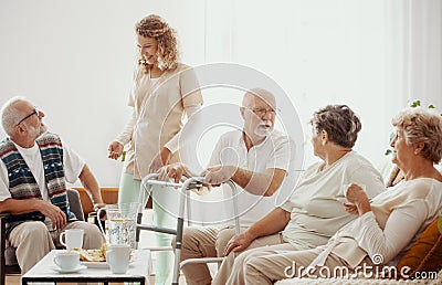 Elders spending time in the common room of the care home Stock Photo