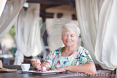 An eldery woman sitting in the coffe house. Stock Photo