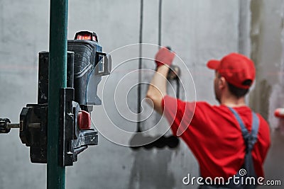 Elecrician work. electric wall outlet installation with laser level Stock Photo