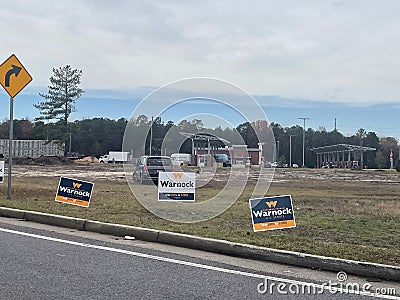 Election street signs vote for Warnock close up Editorial Stock Photo