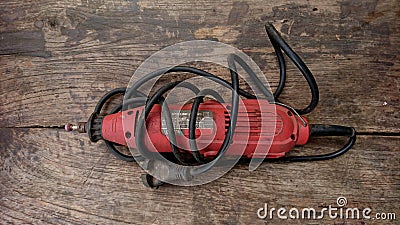 Electric bolt opening machine with wires wrapped around the background of old boards Stock Photo