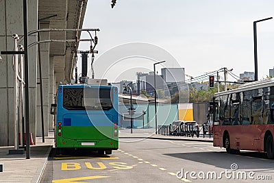 Electric bus at a stop is charged by pantograph. Clean mobility Stock Photo